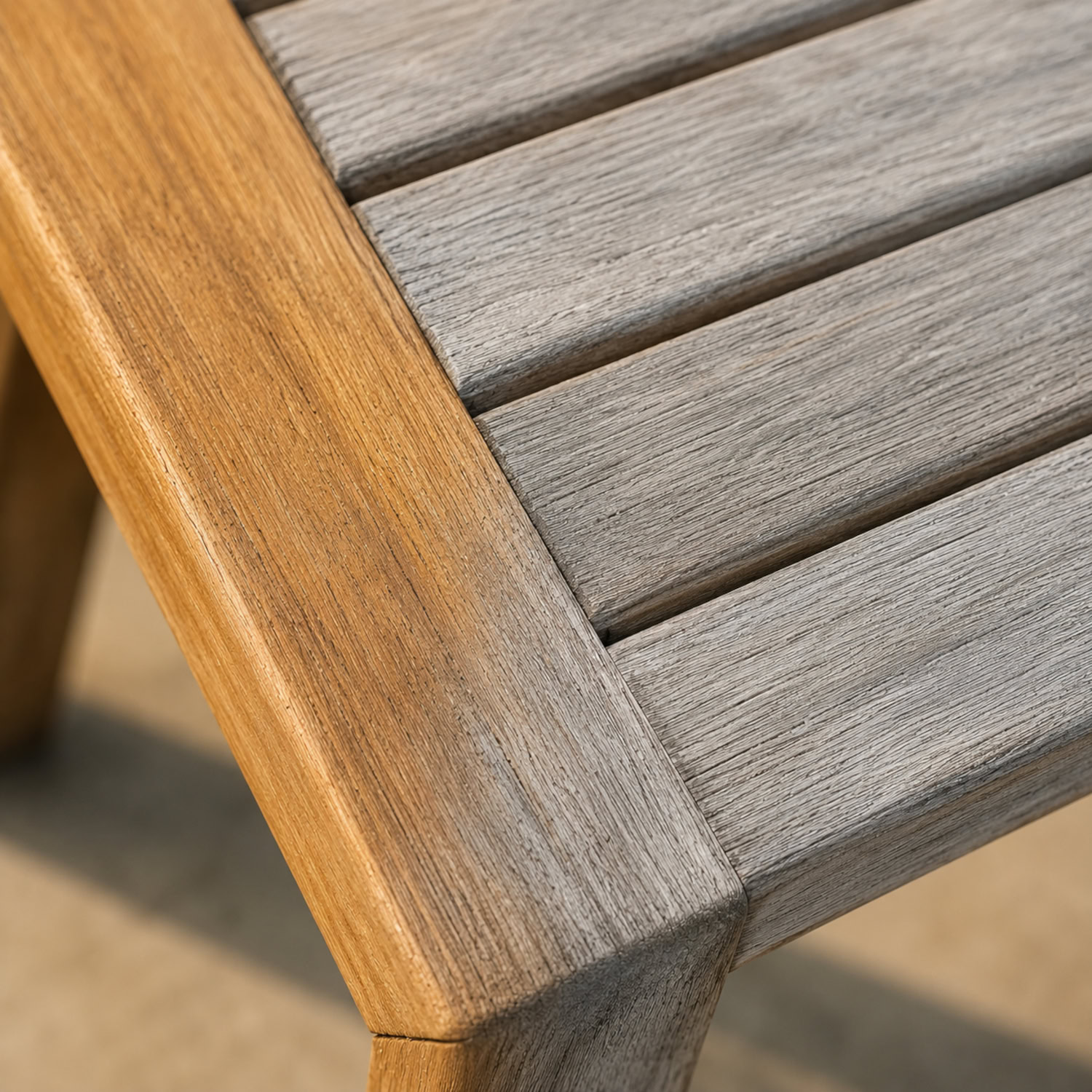 Close-up of teak wood grain showing golden tone fading to silver patina